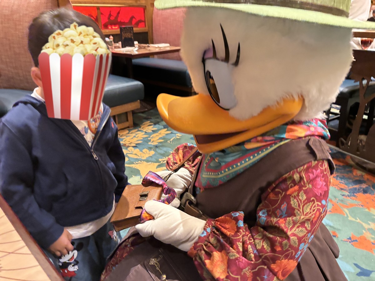 ストーリーテラーズカフェで息子の目線に合わせてしゃがんでくれているデイジーダックと息子の写真